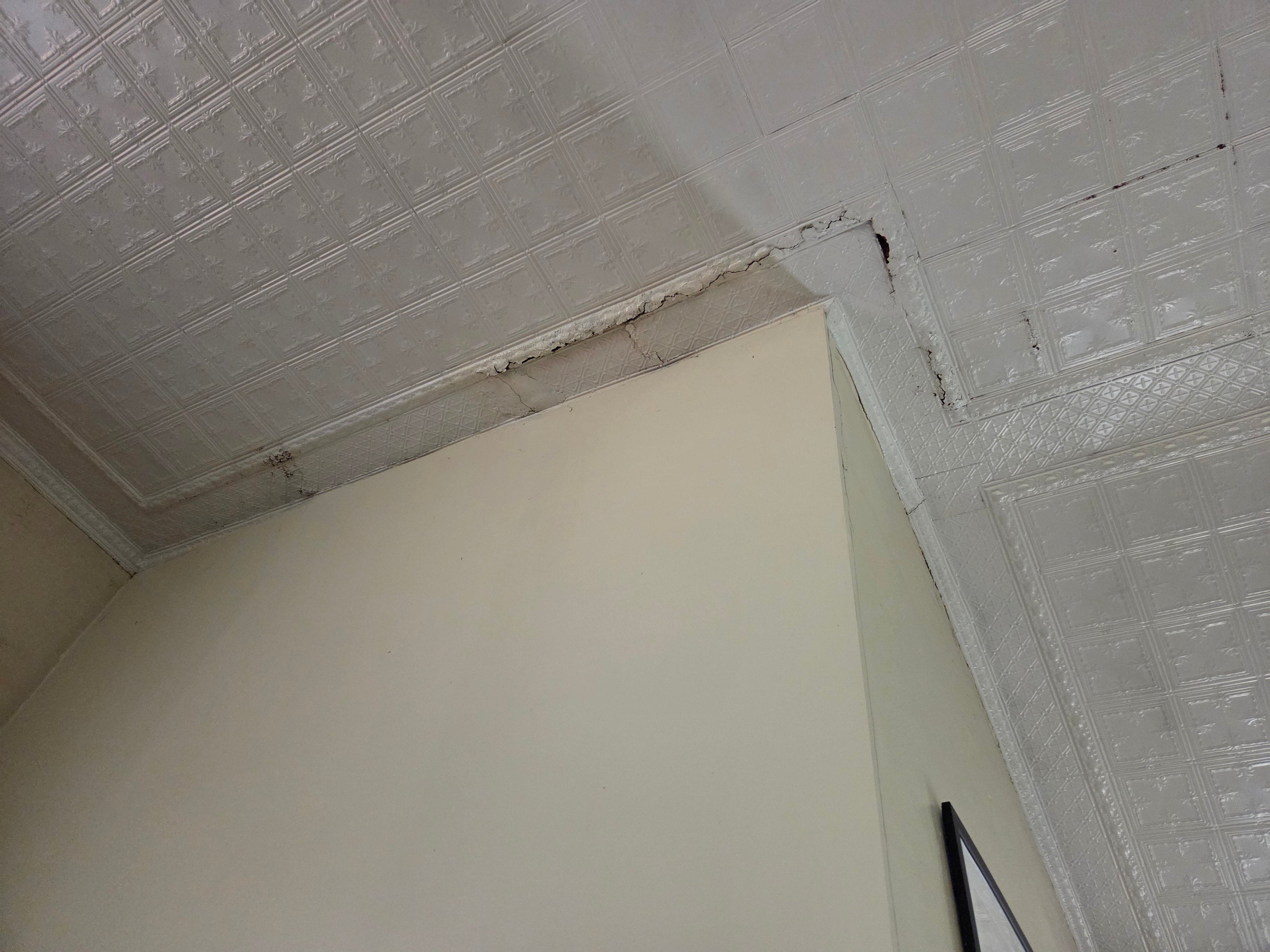 The bell tower wall and the sanctuary's ornate metal ceiling are both simultaneously rotting away.